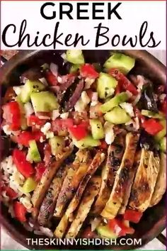 greek chicken bowls with cucumbers, tomatoes and other vegetables in a bowl on a table