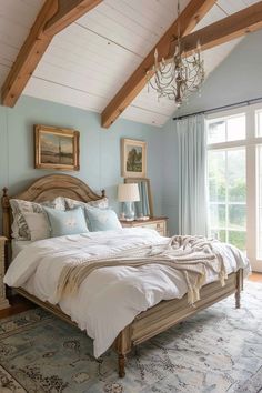 a bedroom with blue walls and white bedding