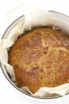 a round loaf of bread in a white bowl