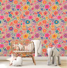 a child's room with colorful wallpaper and an elephant toy on the floor