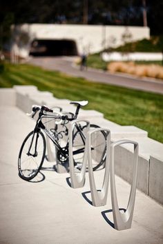 two bikes parked next to each other on the sidewalk