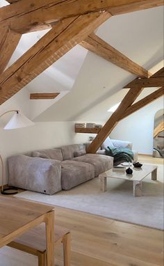 a living room with wooden beams and white walls