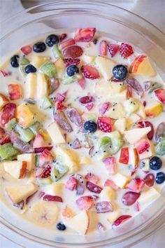 a glass bowl filled with fruit and yogurt