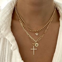 Angelic cross necklace with cubic zirconia detail. Perfect to wear alone or to layer with other necklaces 14k Gold Filled Chain 14k Gold Filled Charm Chain length: 18” Lobster clasp closure Hypoallergenic Water resistant & tarnish free Nickel & lead free Necklace Stacking Gold, Stacked Gold Necklaces, Black Women Jewelry, Necklace Layering Ideas, Layering Necklaces Gold, Layered Necklaces Gold, Necklaces Layering, Classic Pendant Necklace, Necklaces Chunky