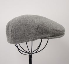 "The Jeff cap is a classic flat cap also sometimes called an ivy cap or driving cap. Each cap is constructed with the highest attention to detail and fine workmanship. Your cap will be made custom to your size and fabric specifications and finished with millinery grosgrain, petersham, and/or other professional sweat banding materials to suit the style of your cap. The brim is constructed over an industry standard cap insert made of high density foam board and is shapeable. Your handmade custom c Classic Flat Cap For Sports, Classic Sports Flat Cap, Classic Flat Cap Fitted Hat For Sports Events, Driving Cap, Ivy Cap, Custom Caps, Cap For Men, Handmade Lighting, Newsboy Cap