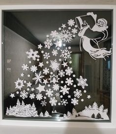 a window with snowflakes and santa claus on it