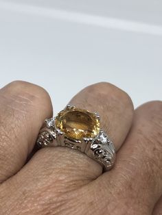 Unusual cut of citrine surrounded by white sapphires Sterling Filigree finished Setting Handmade Size 6 Can be resized, my jeweler charges a $10 fee All rings are shipped in a nice gift box. Check out our over a THOUSAND great reviews Engraving is $4 per letter and is not always perfect depending on the piece. It can take a few days if the jeweler is busy. This is payable to Paypal Judithsltd@gmail.com White Gold Citrine Jewelry With Center Stone, White Gold Citrine Jewelry With Accent Stones, Elegant Yellow Sapphire Sterling Silver Ring, Silver Jewelry With Yellow Sapphire For Anniversary, White Gold Topaz Ring With Citrine, Silver Yellow Sapphire Jewelry For Anniversary, White Gold Citrine Topaz Ring With Center Stone, Fine Jewelry Citrine Topaz Ring With Accent Stones, Elegant Yellow Sapphire Topaz Ring With Accent Stones