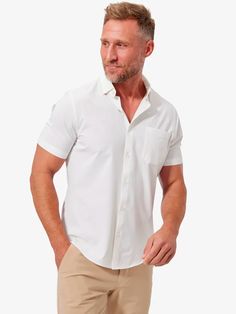 The OG. There’s a reason they (we) call this The Best Damn Dress Shirt. The world’s first performance fabric dress shirt isn’t limited to a long sleeve version. If you’re looking to make your go-to weekend style that much more comfortable, the Short Sleeve Leeward is your guy. Stretchy, moisture-wicking fabric moves with you day and night in this fresh sport shirt that resists wrinkles and makes an ideal travel companion. The Leeward Short Sleeve Performance Button-Up Shirt in crisp solid white Nice White Dresses, Wedding Groomsmen Attire, Khaki Pants Men, White Button Down Shirt, White Short Dress, White Button Up, White Solid, Weekend Style, Mens Button Up