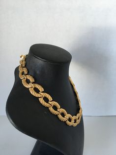 This is a gorgeous gold tone rope link vintage necklace featuring a choker length, a curb chain, a two-part push clasp (box clasp) closure with minimal signs of wear. Please note that vintage items are not new and therefore might have minor imperfections. Designer Style The necklace measures approximately 16 inches and 3/4 inches wide. In excellent condition. Prices are listed for Canada and USA only but if you wish to have them shipped elsewhere, please message me the shipping address and I wil Vintage Chain Choker Necklace, Vintage Choker Chain Necklace, Vintage Gold Choker For Formal Occasions, Formal Rope Chain Necklace, Vintage Oval Link Chain Necklace For Formal Occasions, Vintage Style Chunky Chain Necklace As Gift, Vintage Chunky Chain Necklace As Gift, Vintage Gold-tone Metal Chain Necklace, Vintage Yellow Gold Chain Link Necklace