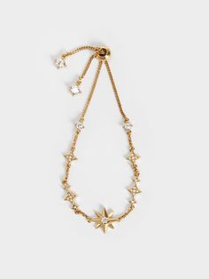 In a luxurious gold-tone finish that boasts a lustrous shine, this star motif bracelet will add a brilliant finish to any outfit. Featuring a crystal-embellished star centrepiece and more charms lined along the wrist chain, this gorgeous bracelet will garner praise and compliments wherever you go. Style it with matching gold jewellery that are also embellished with dazzling gems for an opulent look. Gold Prom Accessories, Star Centerpieces, Jewelry Wishlist, Wrist Chain, Star Bangle, Dainty Jewellery, Star Motif, Prom Accessories, Wrist Jewelry