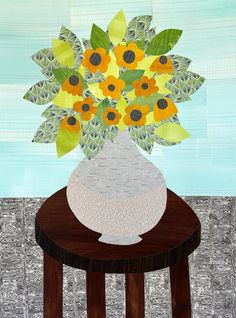 a vase filled with yellow flowers on top of a wooden table