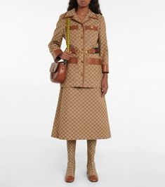 Gucci - GG canvas and leather jacket | Mytheresa Gucci Brown Outerwear With Pockets, Brown Gucci Outerwear With Pockets, Designer Outerwear With Belted Cuffs, Designer Brown Belted Outerwear, Designer Gucci Outerwear With Button Closure, Chic Gucci Single-breasted Outerwear, Fitted Beige Gucci Outerwear, Gucci Designer Leather Outerwear, Gucci Designer Single Breasted Outerwear