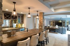 a large kitchen with an island counter and chairs