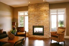 a living room filled with furniture and a fire place in the middle of a room