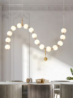 an elegant dining room with white walls and gold accents