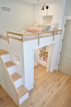 a loft bed with stairs leading up to it