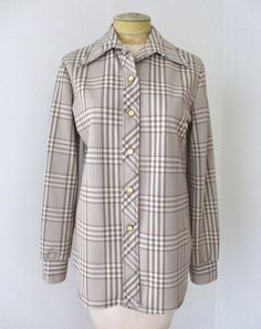 Groovy vintage 1960's or 70's brown and white mixed plaid textured polyester knit button front blouse, maker unknown. Features - dagger point collar - one button cuffs - cream and brass bullseye buttons - straight hem with round split corners APPROXIMATE MEASUREMENTS in inches - lying flat Size:  Unknown, likely Medium to Large Shoulder to shoulder:  16 Sleeve, from shoulder:  25 Chest, armpit to armpit:  20 Waist:  19 Length, center back:  29 CONDITION Very good to excellent vintage condition w 70s Mod, Academia Fashion, Button Blouse, Blouse Top, Top Blouse, Plaid, Knitting, Mens Tops, Quick Saves