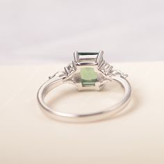 All HANDMADE ITEMS SHIP IN APPROX 8 DAYS Main Stone: Lab created green sapphire Main Stone Size: Emerald cut 6 mm x 8 mm Main Stone Weight: 1.75 carat Side Stone: CZs Height From The Ring Setting Bottom(to gemstone top): about 5.13 mm Width of Ring band Measure: gradually varied,about 1.67 to 1.91 mm Material: .925 Sterling Silver/14K White Gold/14K Yellow Gold/14k Rose Gold Engraved: Available For FreeNo more than 13 letters) Customized:Of course! Tell me what you want Includes With Order: All Modern Green Emerald Ring With Accent Stones, Green Sapphire Ring With Baguette Cut, Rectangular Emerald Ring In White Gold, Square Cut Emerald Ring In White Gold, Silver Radiant Cut Emerald Ring For May Birthstone, Green Sapphire Ring With Prong Setting, Emerald Cut, Rectangular Silver Emerald Ring For Formal Occasions, Modern Emerald Promise Ring, Rectangular Shape, Radiant Cut Silver Emerald Ring For May Birthstone