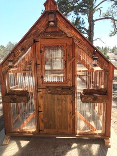 a small wooden building with glass doors and windows