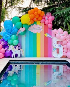 there is a pool with balloons and unicorns on it