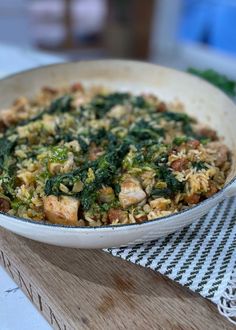 a white bowl filled with food on top of a wooden table