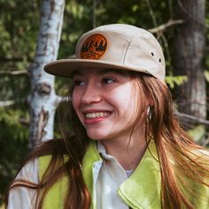 Get Fired Up for Adventure with this Campfire Cap! The patch on this hat features a classic campfire scene, capturing the timeless allure of the great outdoors. It's a simple yet evocative image: two logs ablaze with flames reaching upwards, cradled by a circle that hints at the unity and completeness of nature. The trees standing sentinel on either side anchor the scene in the wild, calling to mind the serenity of the woods and the simple pleasures of a fireside chat under the stars. Each cap i Campfire Scene, Jockey Hat, Field Notes Cover, Moleskine Cover, Fisher Space Pen, Leather Mouse, Leather Mouse Pad, Oxblood Leather, Cord Wrap