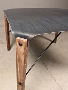 a wooden table sitting on top of a tiled floor