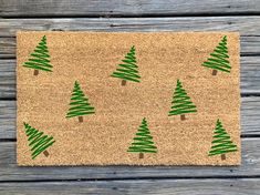 a door mat with green christmas trees on it