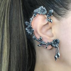 a close up of a woman's ear with flowers on it