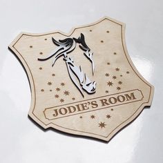 a wooden sign that says jodie's room on the side of a wall