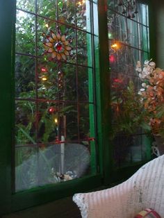 the window is decorated with christmas lights and flowers