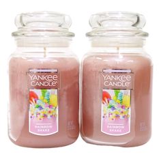 two yankee candles are sitting next to each other