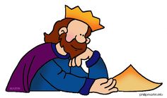 a man with a crown on his head sitting at a table and looking over papers