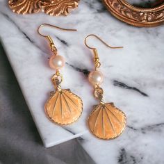 Handmade pale orange pearl and shell earrings. Made in Chichester with loving care. All orders come packed within a lovely Oganza bag. Lovely to wear for any occasion. Statement earrings. Length - 5cm Width - 3cm Made to order and dispatched in one working day. Free standard 2nd class delivery. Upgrade to 1st class for 90p with our express delivery service.  Any questions always feel free to ask, I will respond back very quickly. Thank you ❤️ Shell-shaped Pearl Charm Earrings As Gift, Nickel-free Shell Gift, Shell-shaped Pearl Earrings For Gift, Shell-shaped Pearl Drop Earrings For Gifts, Cute Pearl Drop Earrings As Gift, Cute Pearl Drop Earrings For Gift, Pearl Charm Shell Earrings Gift, Shell Earrings With Pearl Charm Gift, Pearl Shell Earrings Perfect For Gifts