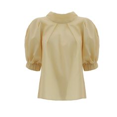 Blouse Add a touch of vintage charm to your collection with this short-sleeve puff blouse, made from a delicate cotton blend. The blouse features a flattering high neckline and voluminous puff sleeves, creating a romantic and feminine silhouette.  Perfect for both casual and formal occasions, this blouse pairs beautifully with high-waisted skirts or tailored trousers. The lightweight fabric ensures comfort, making it an ideal choice for warmer days. Equipped with a zipper. Made in Moldova Artisa Puff Blouse, Waisted Skirts, Shirt Blouses Women's, Yellow Blouse, Feminine Silhouette, Fashion Industry, Tailored Trousers, Independent Designers Fashion, High Neckline