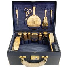 A wonderfully rare antique 14K gold dresser set contains 18 pieces including: 1 hair brush 1 hair comb 1 clothes brush 3 round gold containers 2 glass bottles 3 gold bottles 1 corsette hook 1 shoe horn 1 mirror 1 scissors 1 nail file 1 toothbrush holder 1 carton container Each piece is signed and has a serial number. Circa 1920s. Antique Vanity Set, Gold Dresser, Gold Bottles, Art Deco Vanity, Travel Trunk, Antique Vanity, Dresser Sets, Vintage Cosmetics, Vintage Luggage