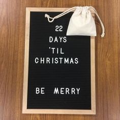 a wooden sign that says 22 days til christmas be merry on it with a drawstring bag