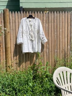 One-of-a-kind.    100% linen body    made from antique linen sourced from central pennsylvania.    grosgrain front tie placket. stepped hem.    machine wash cool water. tumble dry low. iron as needed.    made in usa. Folk Style Long Sleeve Linen Tops, Spring Folk Style Embroidered Linen Dress, Traditional Linen Tops With Chikankari Embroidery, Spring Linen Top With Chikankari Embroidery, White Linen Peasant Top, Spring Linen Top With Broderie Anglaise, Traditional White Linen Blouse, White Linen Top With Broderie Anglaise Detail, White Linen Top With Broderie Anglaise