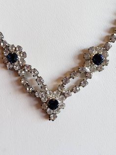 This is a vintage silver tone metal and clear and blue rhinestone necklace. The length is 17 inches. Don't forget to stop in at my other Etsy shop... http://www.etsy.com/shop/xtdesigns. Follow me on Twitter at... MyYiayiaHadThat@MyYiayiaHadThat. If you have a wish list or are looking for something specific, please ask. I may have exactly what you are looking for. As always please convo me with any questions or concerns regarding this item or with any international shipping questions. Unfortunate Vintage Blue Necklace For Evening, Cheap Vintage Silver Rhinestone Necklace, Blue Vintage Crystal Necklaces, Elegant Blue Crystal Rhinestone Necklace, Silver Vintage Rhinestone Necklace For Vintage Events, Vintage Blue Crystal Necklaces, Vintage Necklaces Blue Rhinestones, Vintage Blue Rhinestone Jewelry, Something Old