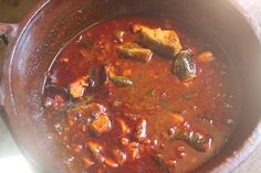 a pot filled with stew sitting on top of a table