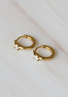 Featuring a tiny round CZ. Perfect for every day and layering. These earrings are meant to be worn close around the earlobe. Base Material: High Quality 925 Sterling Silver Finish: 18K Gold or Platinum Measurements: 9mm hoop, 2mm stone Nickel Free Made in United States Weight: 2.1 oz (59 g) Tiny Round Huggie Earrings For Anniversary, Tiny Cubic Zirconia Cartilage Earrings For Everyday, Dainty Everyday Huggie Earrings, Dainty Round Huggie Earrings, Single, Dainty Round Huggie Earrings, Everyday Round Cubic Zirconia Cartilage Earrings, Dainty Single Round Huggie Earring, Everyday Gold Round Cut Huggie Earrings, Everyday Round Huggie Earrings With Prong Setting