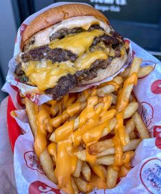 a cheeseburger and fries are in a basket