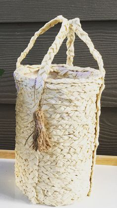 a large white basket with rope handles