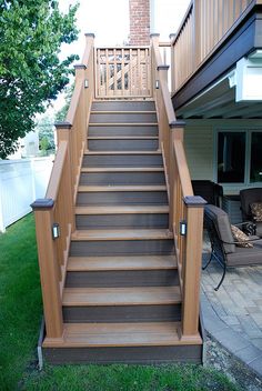 a set of stairs leading up to a patio with chairs and table in the background