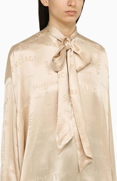 This champagne-coloured silk shirt is the epitome of effortless elegance, perfect for adding a touch of luxury to any outfit. With its long sleeves and subtle tone-on-tone all over lettering logo, it's a timeless piece with a modern twist. The bow fastening at the neck adds a feminine touch, making it a versatile and chic addition to any wardrobe. 100% silk material for a luxurious look and feel Tone-on-tone all over lettering logo for subtle branding Bow fastening at the neck for a feminine tou Silk Bow, Lettering Logo, Effortless Elegance, Silk Material, Champagne Color, Monogram Logo, Silk Shirt, Woman Colour, Casual Bags