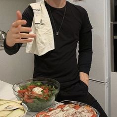 a man standing in front of some food