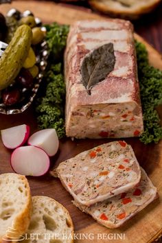 sliced meat and vegetables on a plate with bread slices, pickles, and pickles