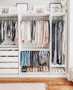 a white closet filled with lots of clothes and shoes on top of wooden shelves next to a rug