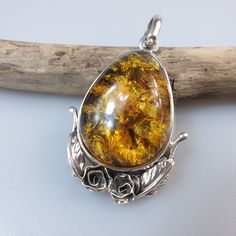 Baltic Amber pendant, silver pendant. Sterling silver 925 with hallmarks . Handmade Christmas gift for women. Stunning green  brown a bit honey colour Amber gemstone.  Weight: 11,40 gr pendant size 4,8 x 3 cm. The back is slightly painted in black. It is to enhance what we see from the front of the Amber. It bring out and show off the sparkle of the inclusions. This item was made of natural Baltic Amber. All the amber used in my jewelry is collected in my home country Lithuania.  I sell only gen Christmas Gift For Women, Amber Brown, Amber Gemstone, Amber Pendant, Honey Colour, Christmas Gift For Her, Handmade Christmas Gifts, Pendant Silver, Christmas Gifts For Women