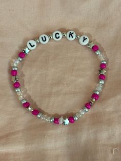 A hand-crafted glass bead friendship bracelet highlighting Halsey's new single "Lucky"! A simple and cute way to show off your favorite song or a great concert accessory!  This bracelet is made with Czech glass beads, plastic letter beads, plastic spacer beads, and is on an elastic thread measured at about 10 inches in length for a relaxed/loose fit. If you would like the bracelet you order to be smaller or larger, please leave the requested size in inches in the personalization box!  All bracelets are made to order and are typically shipped out within 1-3 business days unless otherwise stated. Adjustable Beaded Kpop Bracelets, Adjustable Kpop Bracelets With Letter Beads, Adjustable Kpop Letter Beads Bracelets, Adjustable Kpop Bracelet With Letter Beads, Adjustable Round Beads Kpop Bracelets, Adjustable Kpop Style Friendship Bracelets With Letter Beads, Trendy Silver Friendship Bracelets With Letter Beads, Bead Friendship Bracelet, Plastic Letters